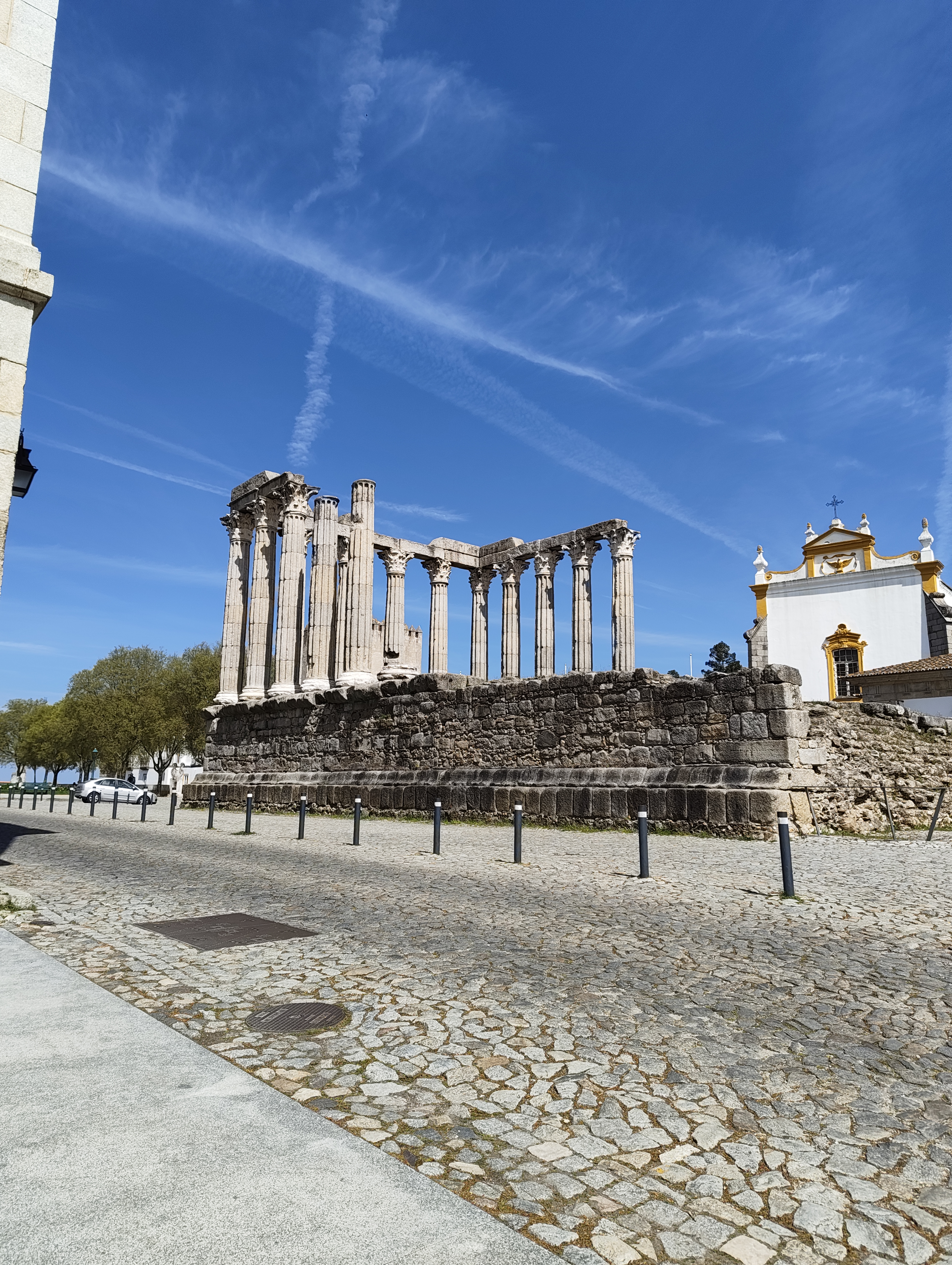 The ancient Roman Temple of Évora — Corinthian columns against a deep blue sky
